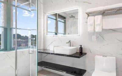 Modern bathroom with plush towels at Liberty View Brooklyn Hotel.