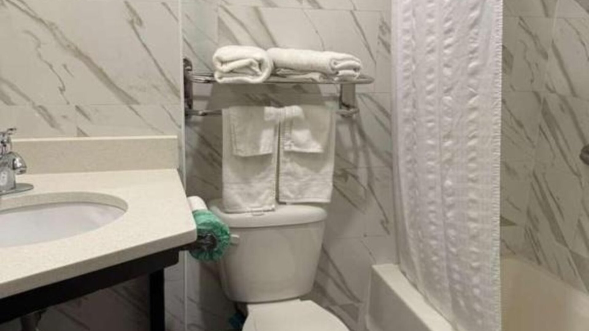 Bathroom with towels at Days Inn By Wyndham Brooklyn Marine Park.