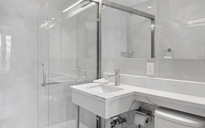 Modern bathroom with towels at Hotel 365 Bronx.