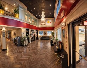 Lobby area with seating at Coratel Inn And Suites By Jasper Wichita North.