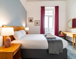 Day room with workspace and a balcony at The Southcliff Hotel.