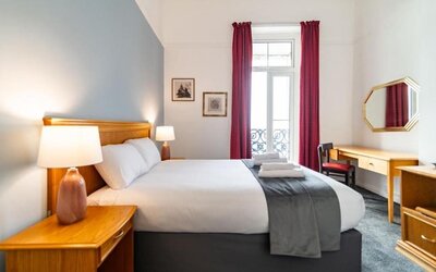 Day room with workspace and a balcony at The Southcliff Hotel.