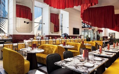 Dining area with booths, bar seating, red accents, and modern lighting design at M Social New York Downtown.