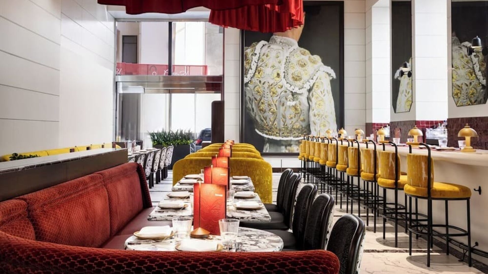 Restaurant interior with booth seating, bar area, and warm lighting at M Social New York Downtown.