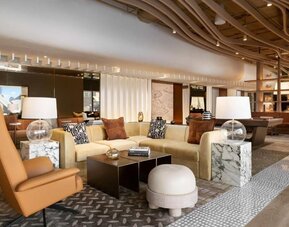 Stylish lobby lounge with sofas, marble tables, decorative lighting, and contemporary design at M Social New York Downtown.