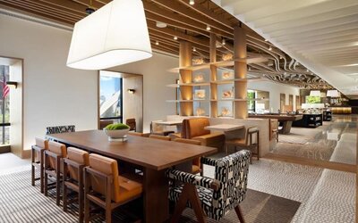 Open lounge and workspace area with communal seating, tables, and modern lighting at M Social New York Downtown.