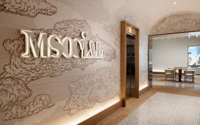 Reception area with illuminated M Social signage, wall art, and elevator access at M Social New York Downtown.