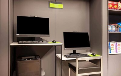 Business center with computers, workspace desks, and printer facilities at La Quinta Times Square South.