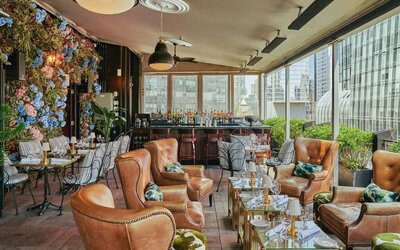 Lounge area with comfortable seating and bar setup at Le Méridien New York, Central Park.
