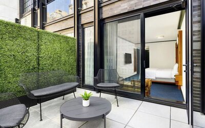 Private balcony with outdoor seating and access to guest room at Le Méridien New York, Central Park.