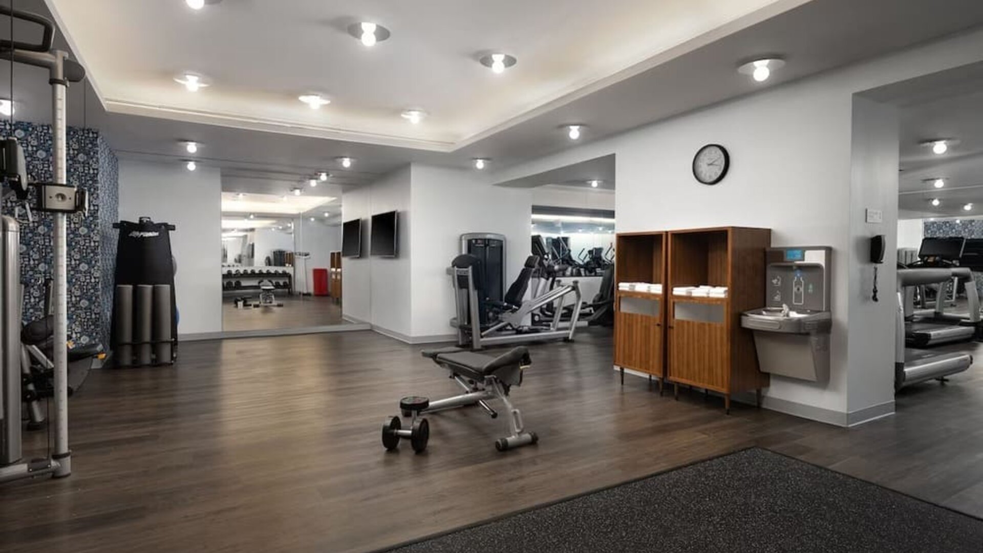 Fitness center with cardio machines, weights, and workout equipment at Le Méridien New York, Central Park.
