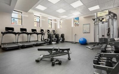 Fitness center with treadmills, weights, and strength equipment at Hotel 57.