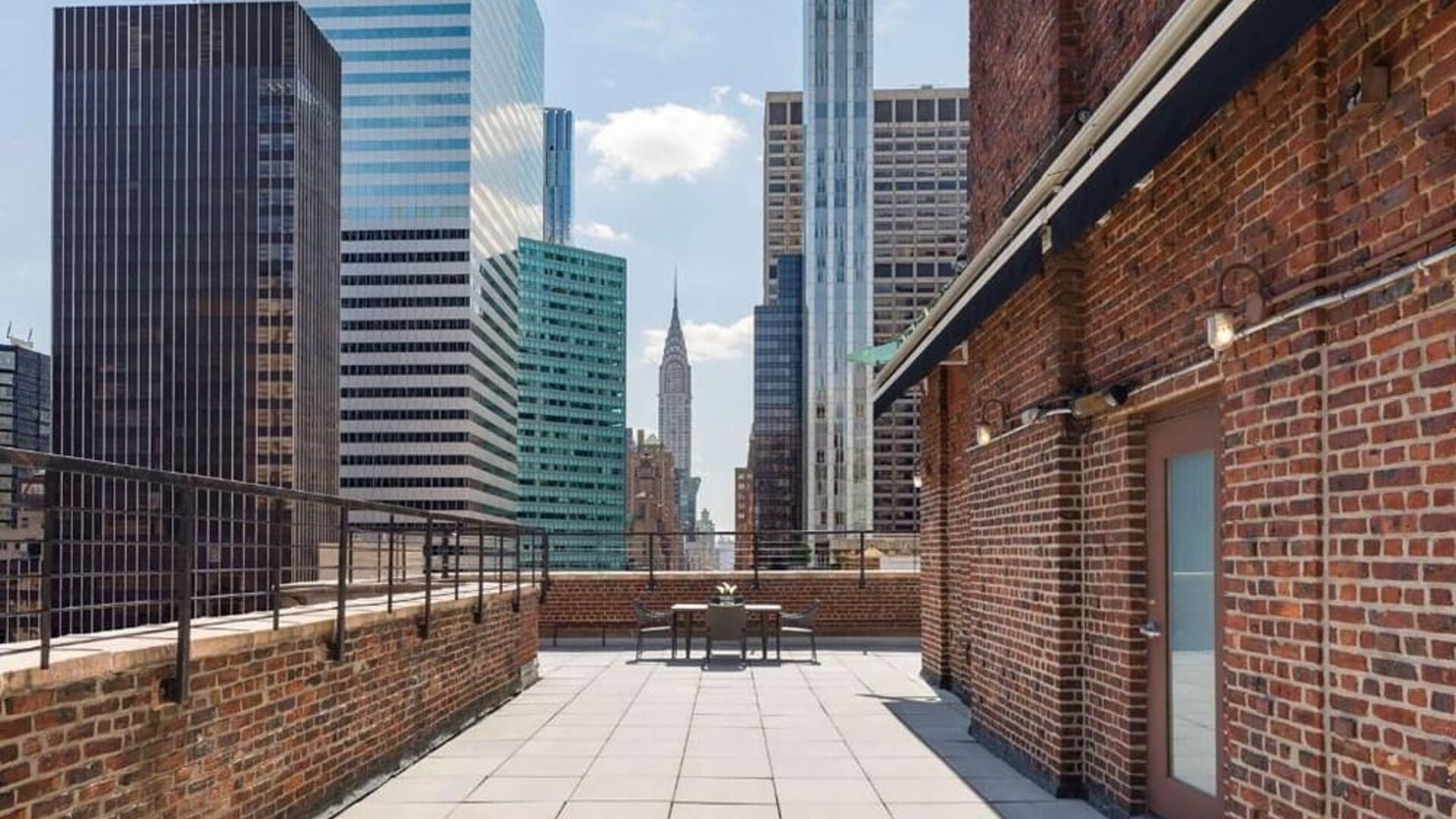 Rooftop terrace with skyline views and outdoor seating at Hotel 57.