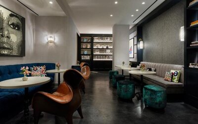Lounge area with seating, tables, and reading space at Hotel 57.