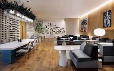 Stylish lounge area with modern seating, soft lighting, and decorative wall features at Timbri Hotel San Francisco, Curio Collection By Hilton.