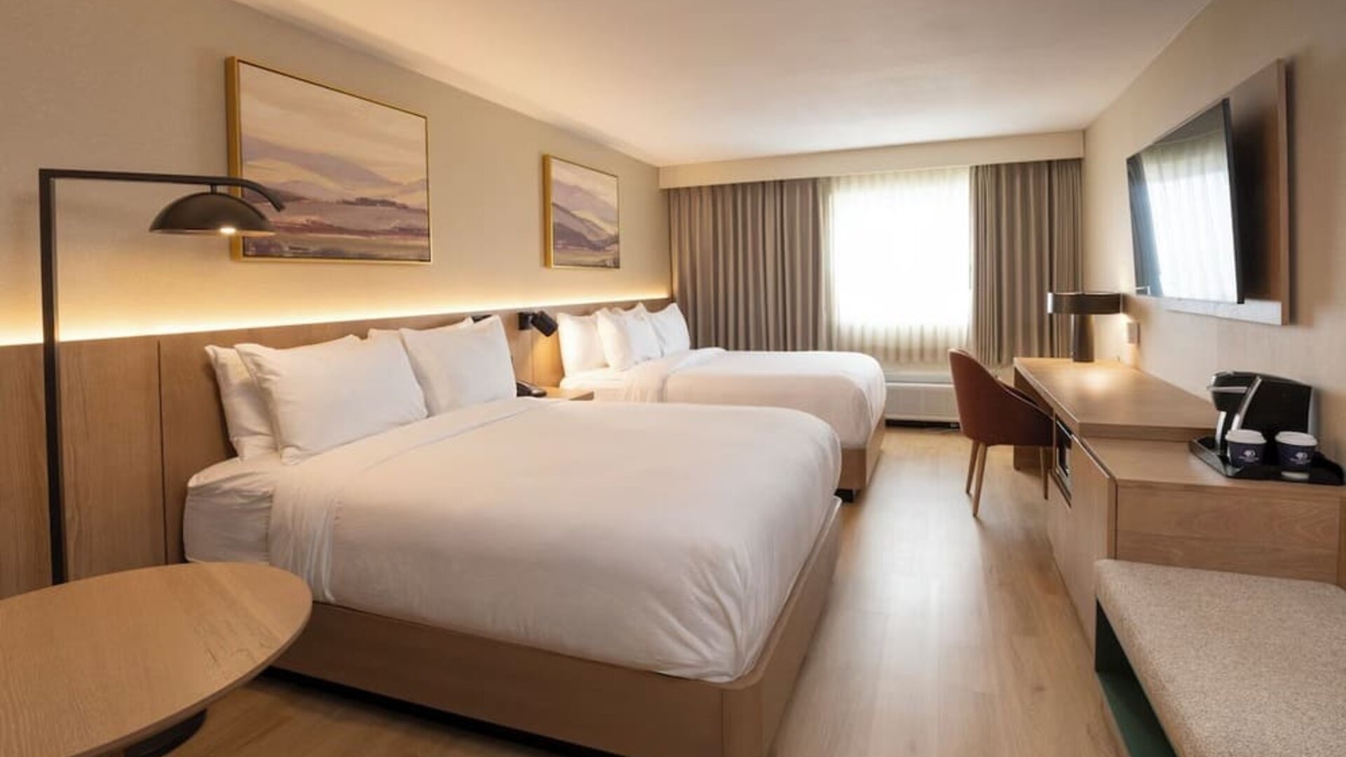 Two queen beds with work desk and natural light at DoubleTree By Hilton Wilkes-Barre.