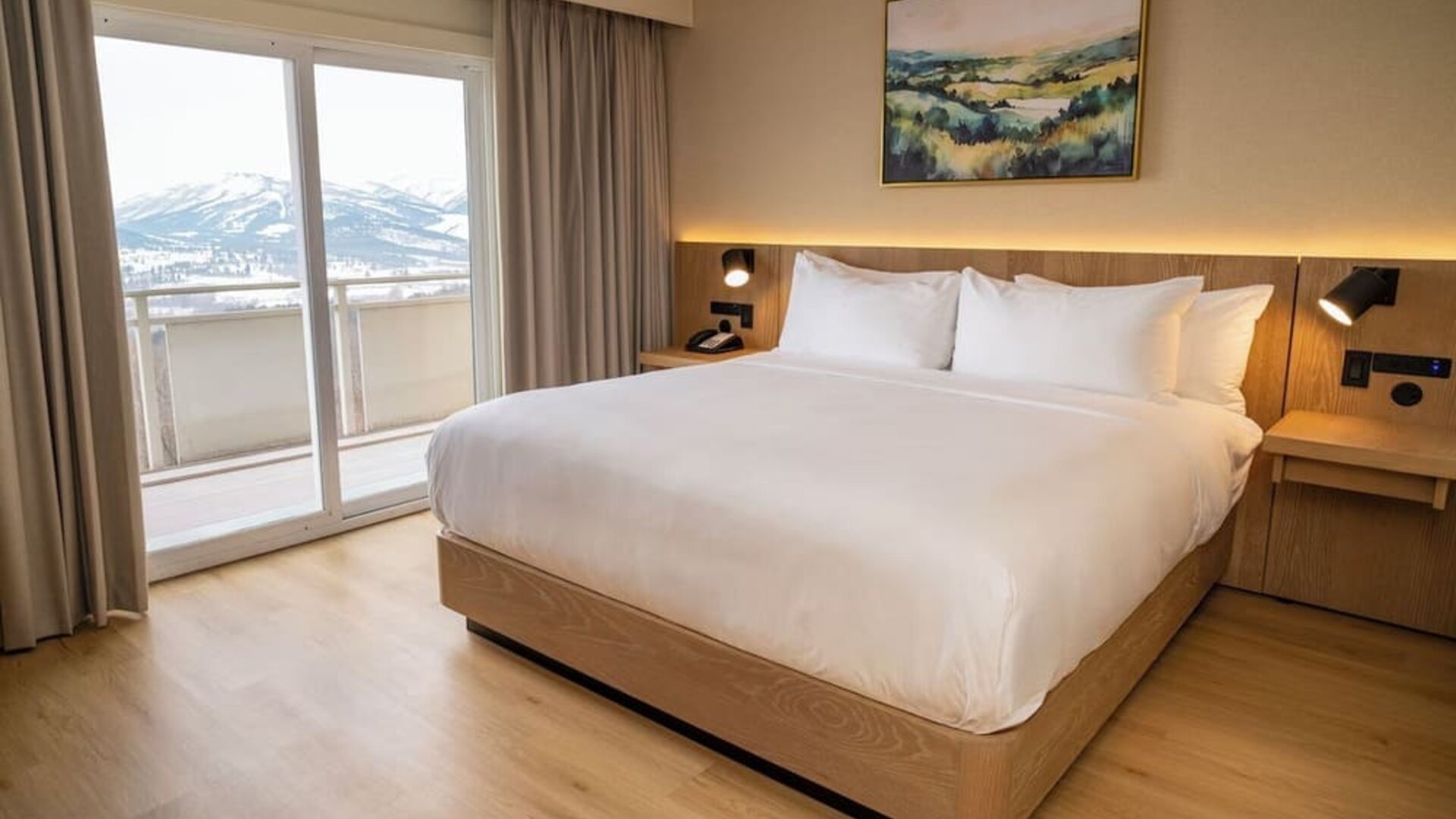 King bed with balcony and outside view at DoubleTree By Hilton Wilkes-Barre.