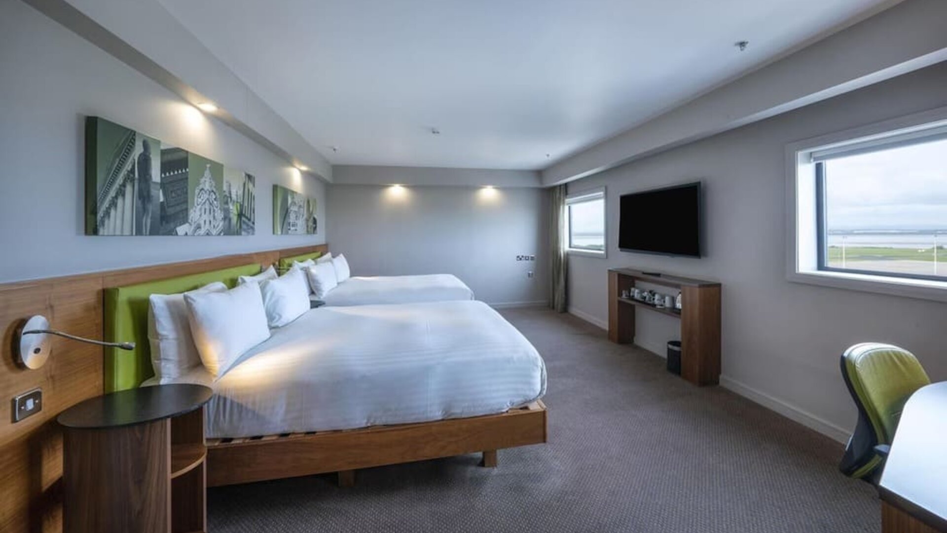 Two queen beds with TV and work desk at Hampton By Hilton Liverpool/John Lennon Airport.