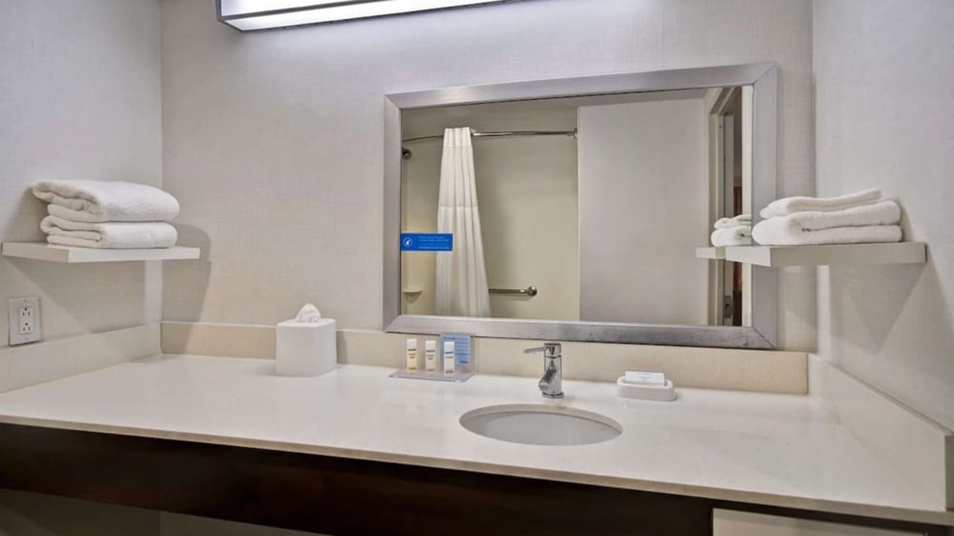 Guest bathroom with shower at Hampton Inn NY-JFK.
