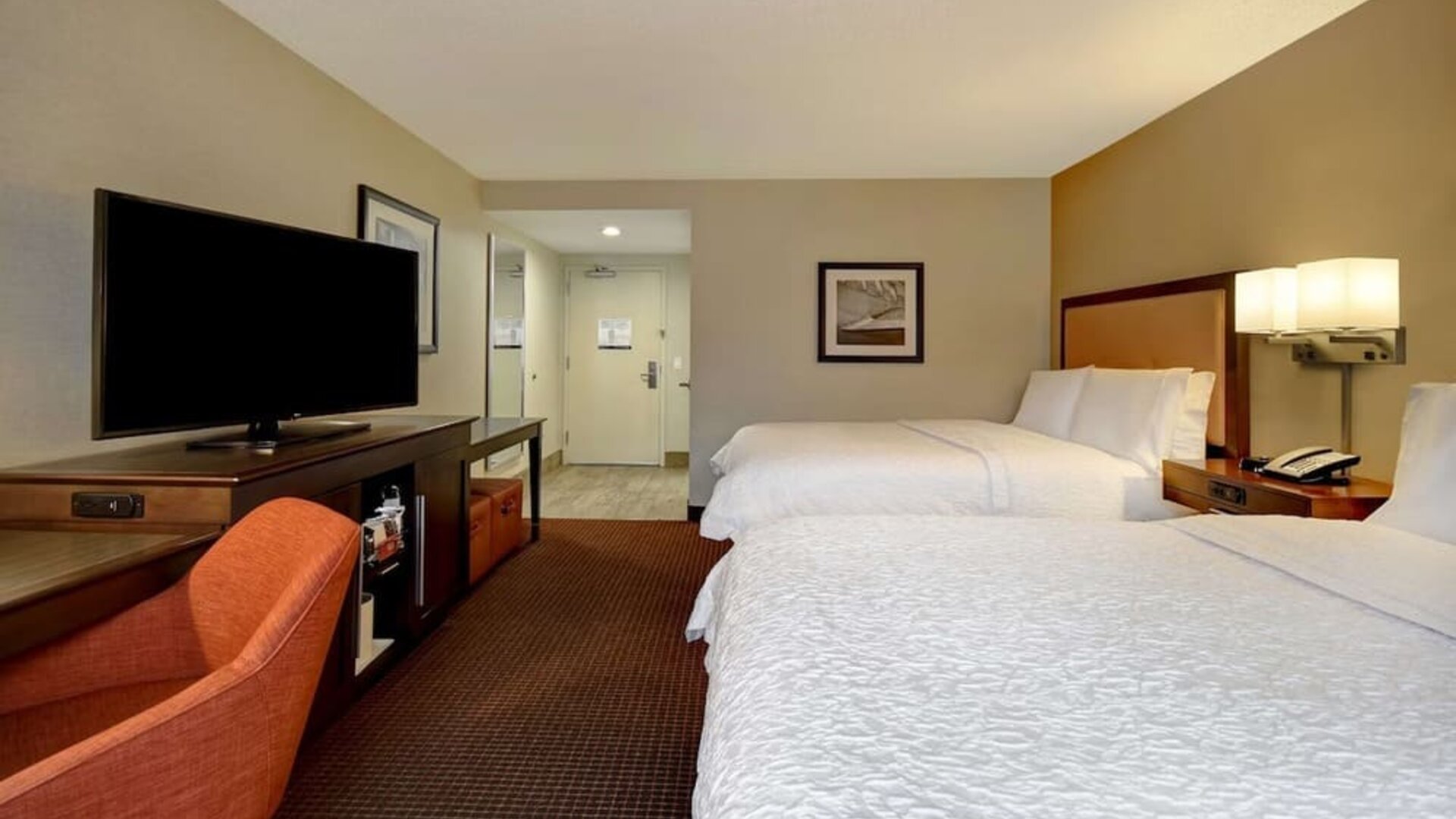 Day use room with two queen beds and work desk and TV at Hampton Inn NY-JFK.