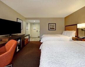 Day use room with two queen beds and work desk and TV at Hampton Inn NY-JFK.
