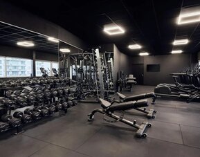 Fitness center with weights at Haven Hotel Rotterdam.