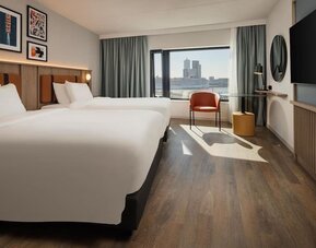 Day use room with two beds and TV at DoubleTree By Hilton Rotterdam Centre.