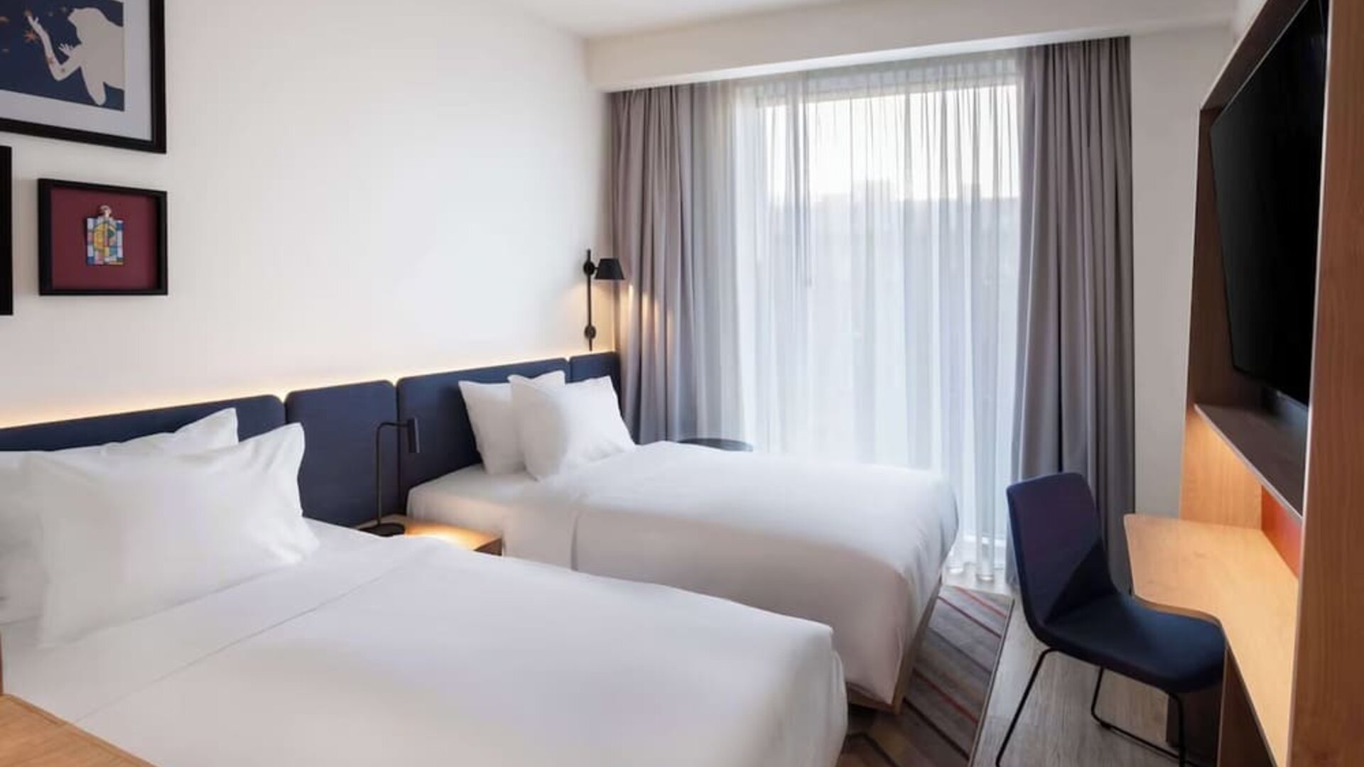 Day use room with two beds, TV, and work desk at Hampton By Hilton Tallinn.