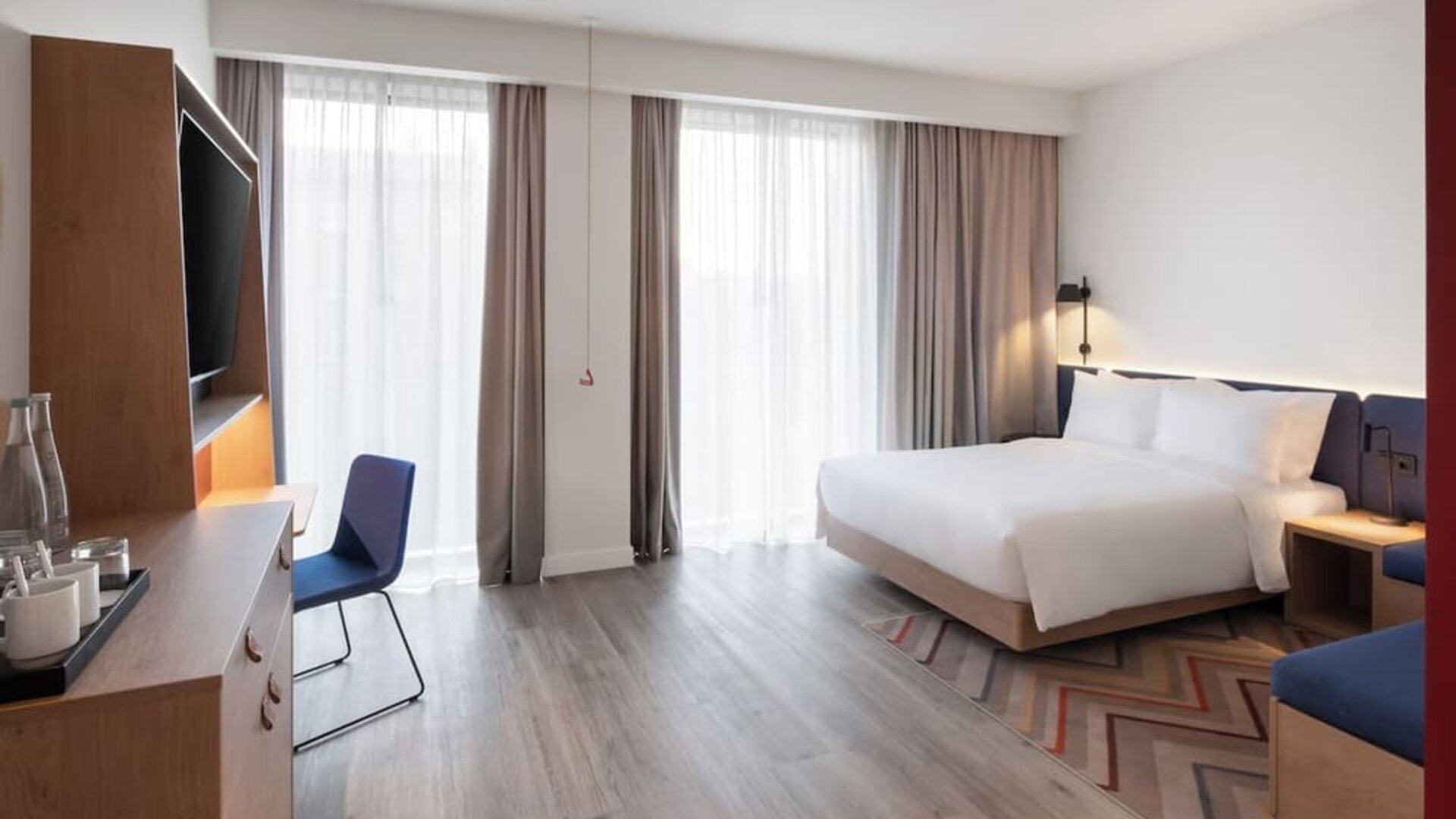 Spacious king room with TV and work desk at Hampton By Hilton Tallinn.