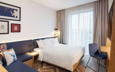 Cozy delux king room with couch at Hampton By Hilton Tallinn.