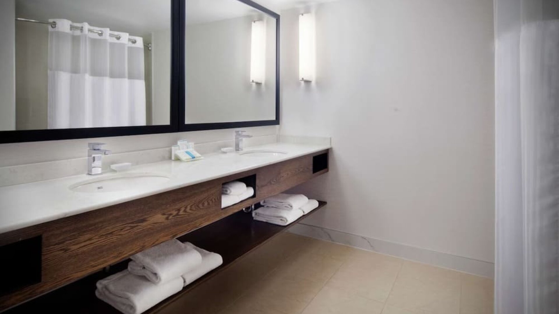 Guest bathroom with shower at Hilton Garden Inn Montreal Airport.
