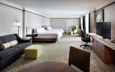 Spacious king suite with couch and TV at Hilton Garden Inn Montreal Airport.