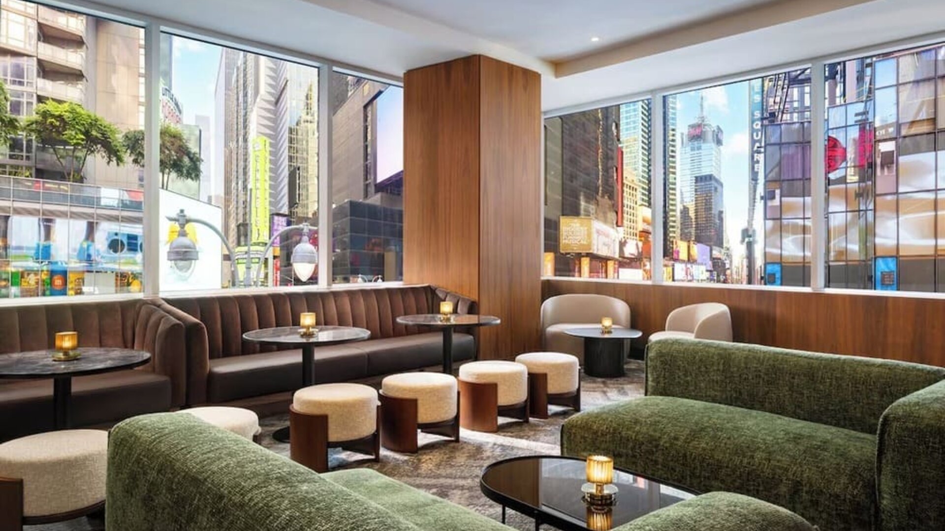 Lounge seating area with city views, sofas, and tables at Hyatt Regency Times Square.