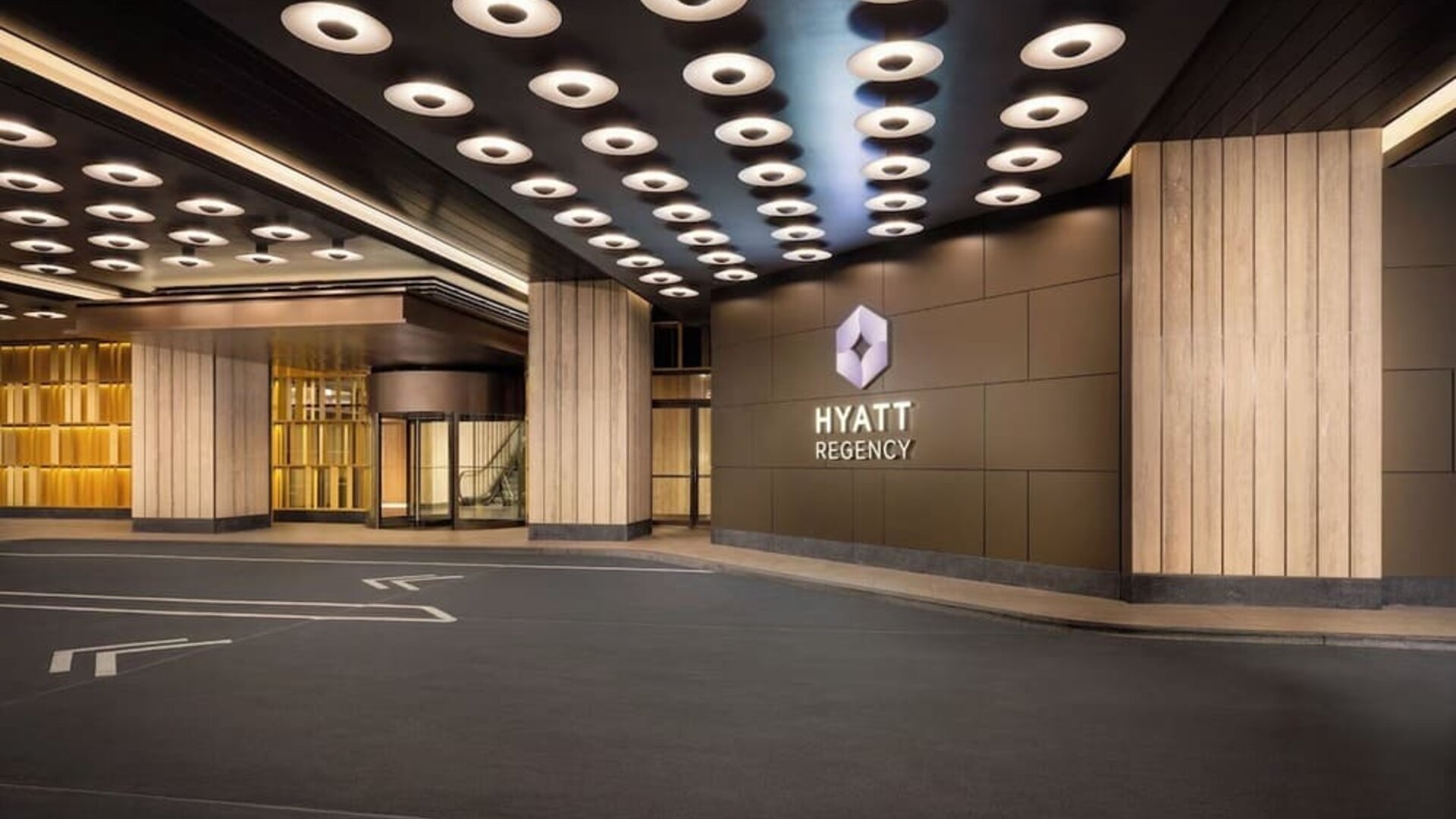Hotel entrance with covered drop-off area and Hyatt Regency signage at Hyatt Regency Times Square.