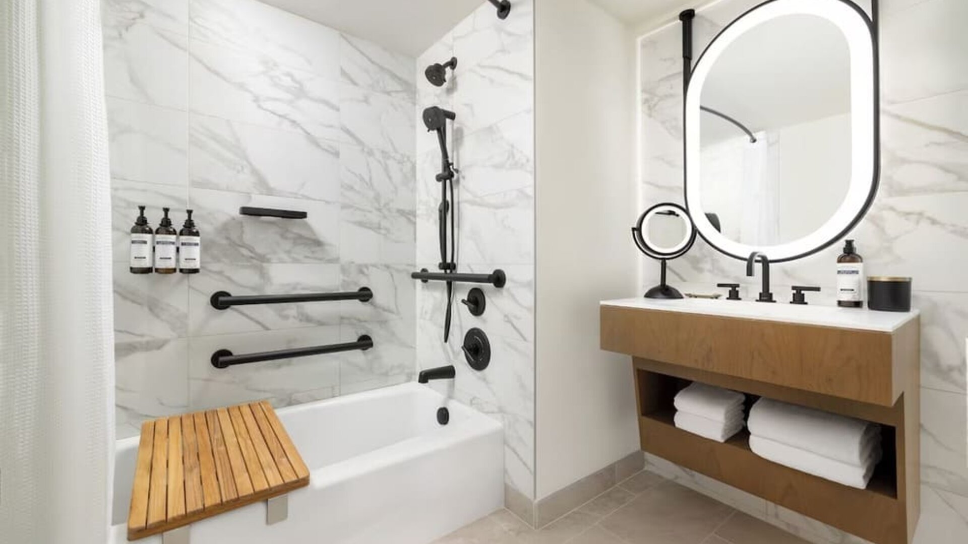 Bathroom with bathtub, shower fixtures, and marble tile finishes at Hyatt Regency Times Square.