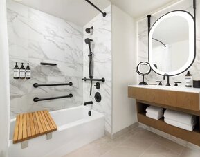 Bathroom with bathtub, shower fixtures, and marble tile finishes at Hyatt Regency Times Square.