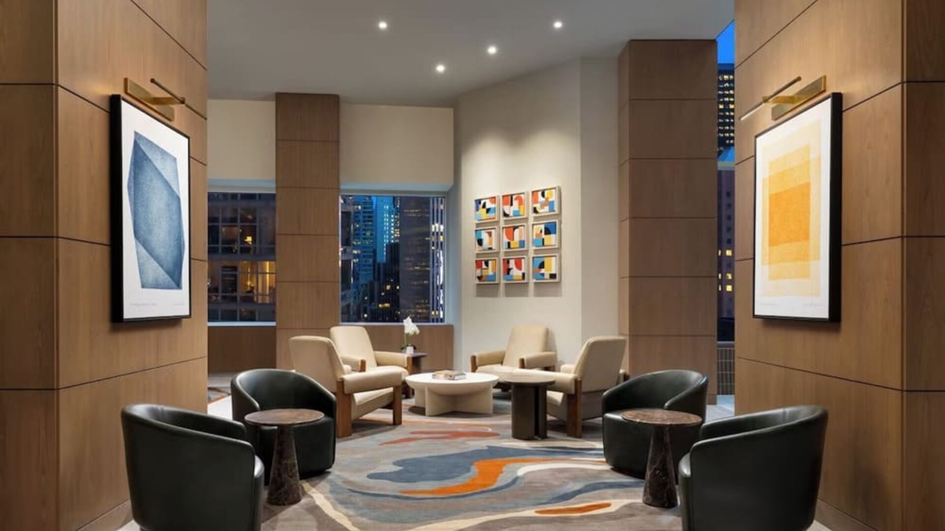 Lobby seating area with modern chairs, artwork, and warm lighting at Hyatt Regency Times Square.