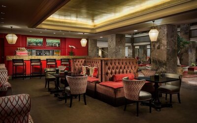 Intimate lounge and bar area with warm lighting, tufted seating, and upscale ambiance at The Michelangelo New York.