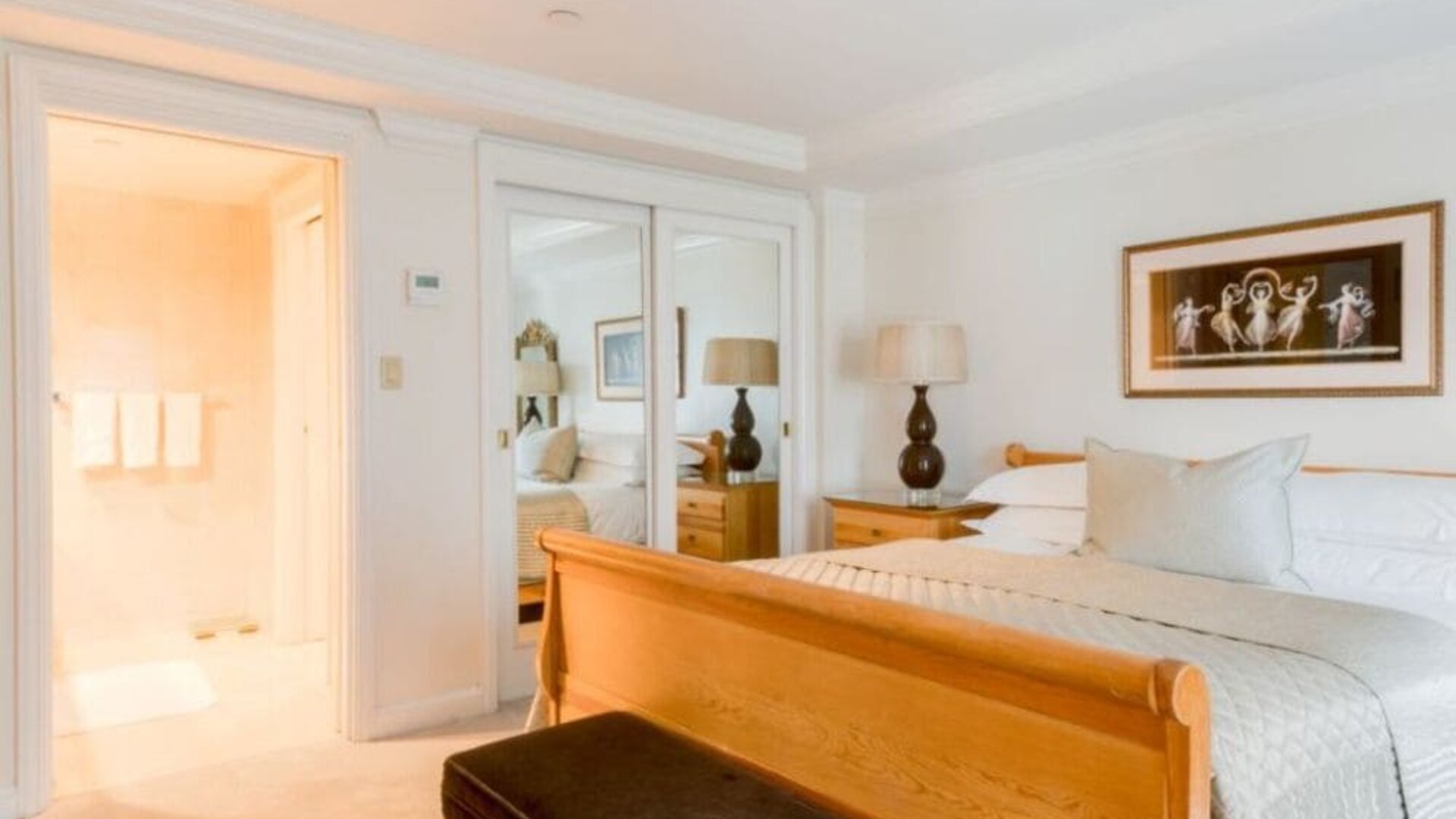 King room with traditional furnishings, large windows, and city skyline views at The Michelangelo New York.