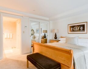 King room with traditional furnishings, large windows, and city skyline views at The Michelangelo New York.