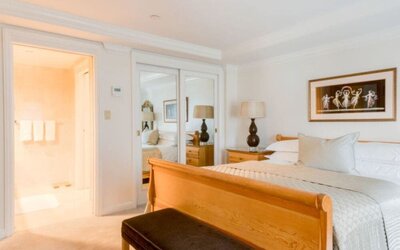 King room with traditional furnishings, large windows, and city skyline views at The Michelangelo New York.