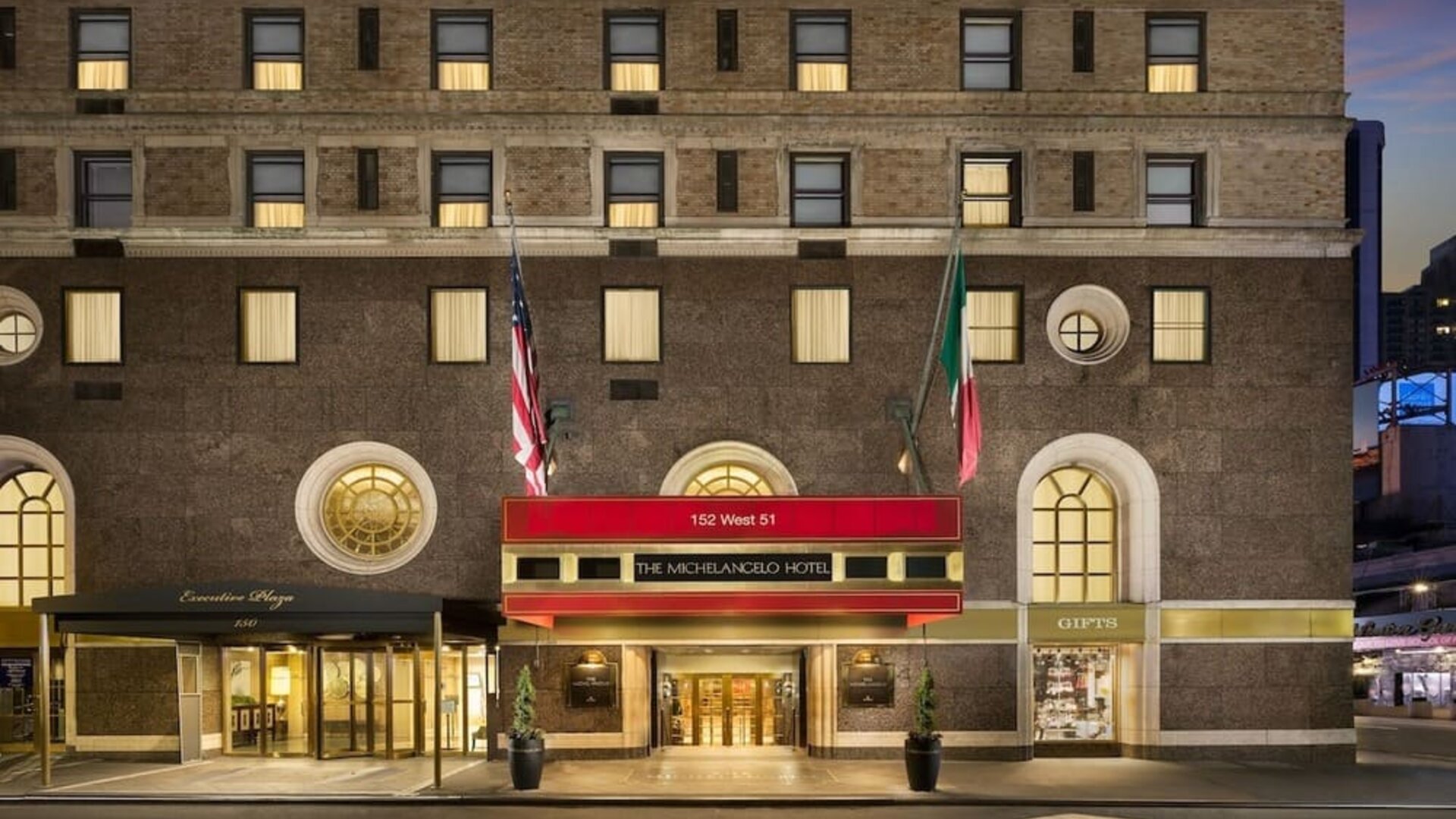 Exterior entrance with signature red awning and classic New York architecture at The Michelangelo New York.
