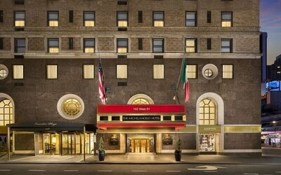 Exterior entrance with signature red awning and classic New York architecture at The Michelangelo New York.