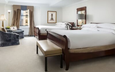 Two-bed guest room with classic furnishings, city views, and ample space at The Michelangelo New York.