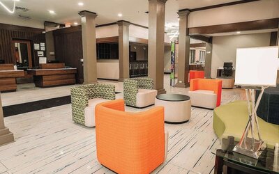 Lobby lounge with colorful seating, open space, and casual atmosphere at Wyndham Garden Williamsburg Busch Gardens Area.
