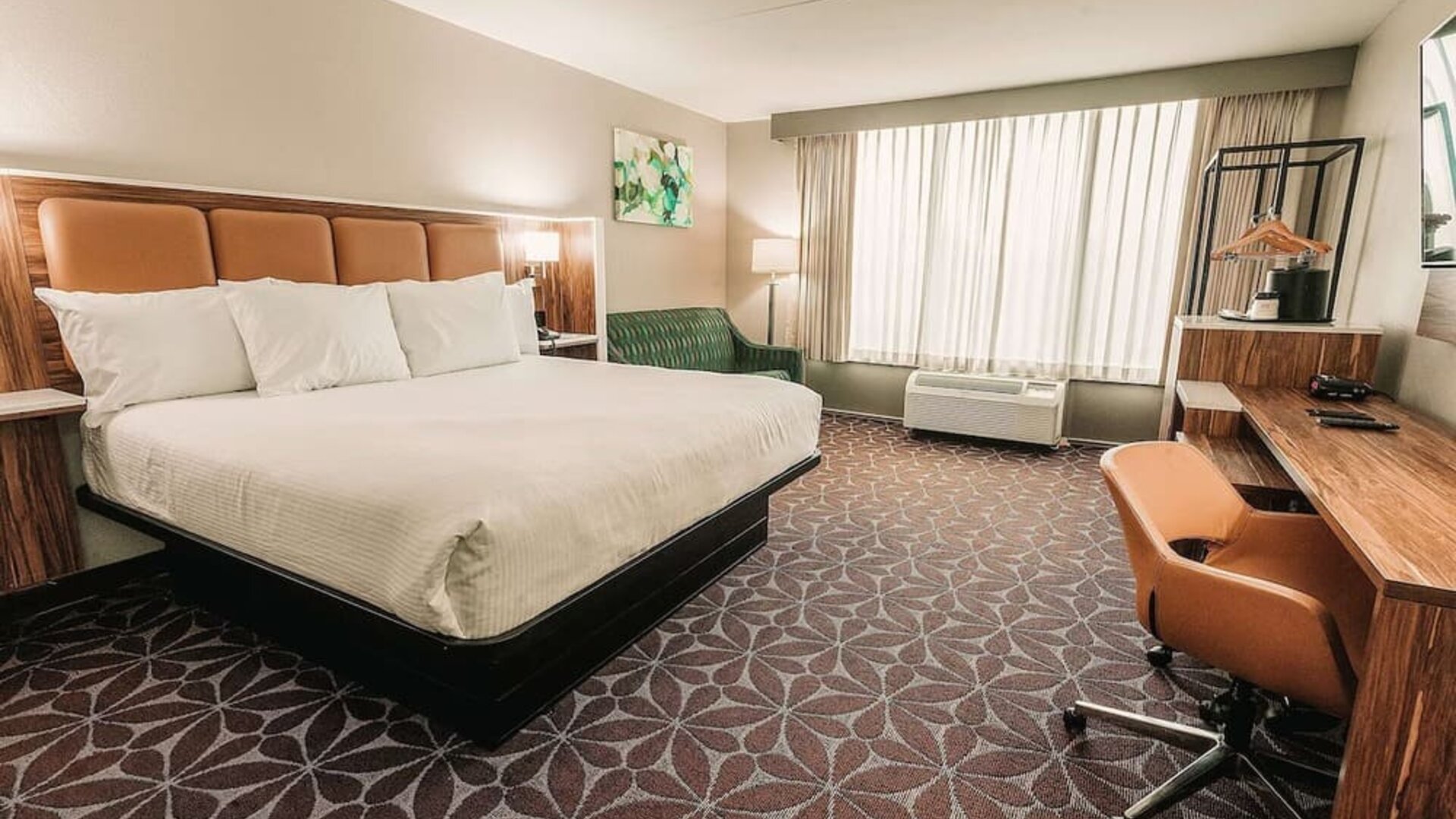King room with large bed, work desk, and contemporary furnishings at Wyndham Garden Williamsburg Busch Gardens Area.