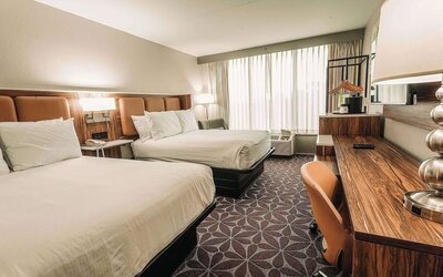 Double room with two beds, workspace, and modern decor at Wyndham Garden Williamsburg Busch Gardens Area.
