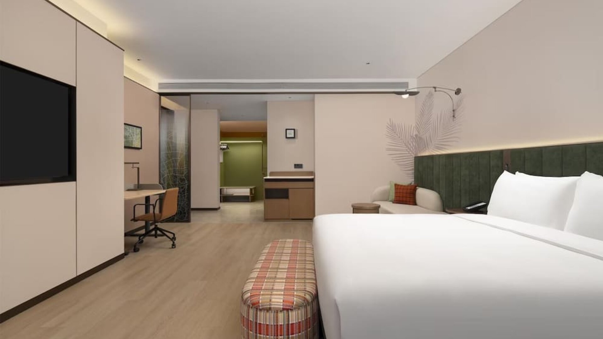 King guest room with plaid bench, workspace, cushioned seating area, and soft recessed lighting