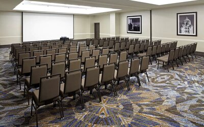 Large meeting and conference room with theater-style seating and projector screen at Embassy Suites By Hilton LAX Airport North.