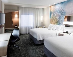 Double queen guest room with modern décor at Courtyard By Marriott Houston North/Shenandoah.
